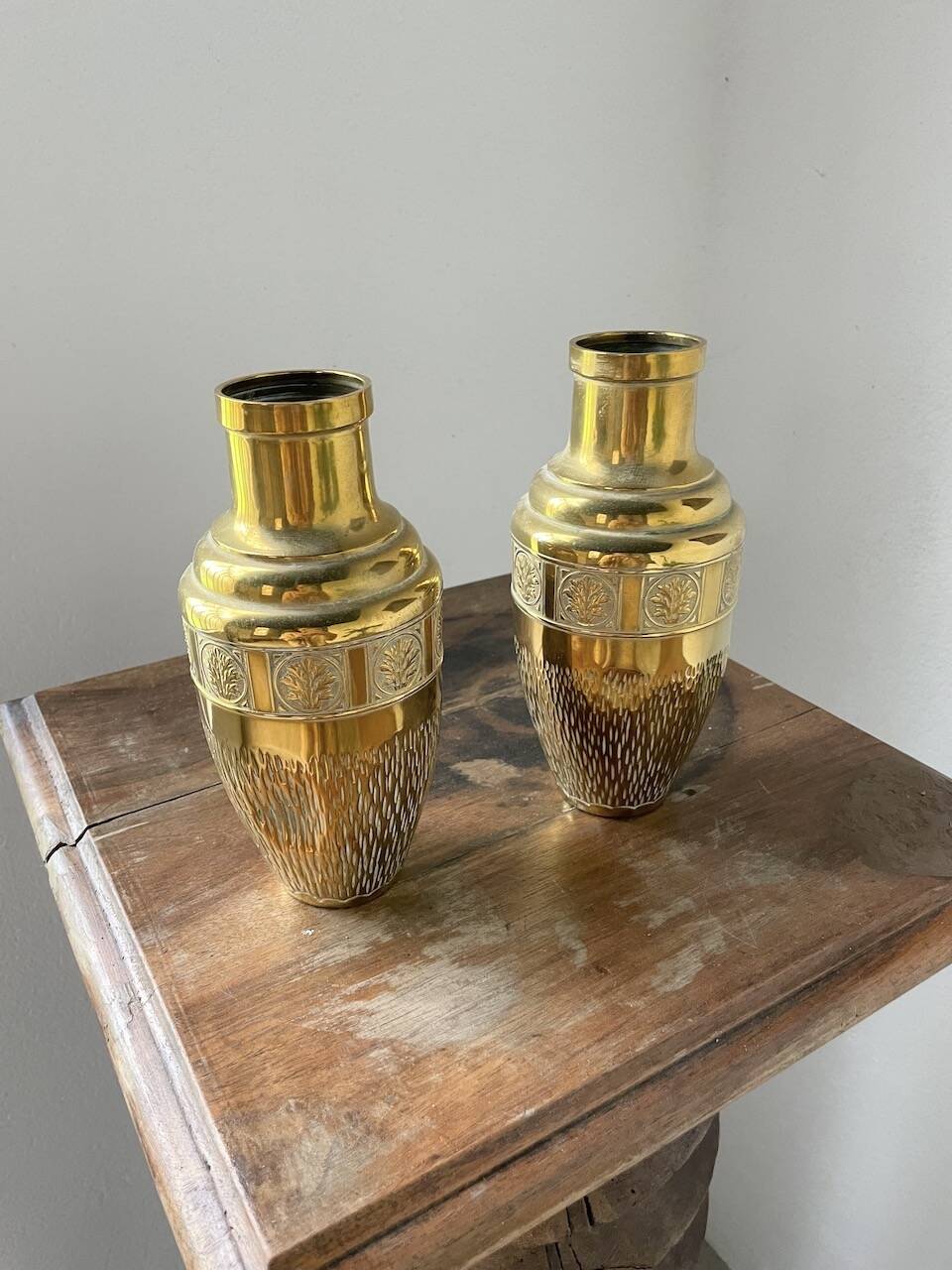 Duo of embossed brass vases