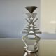 Ethnic “skeleton” candle holder in nickel-plated brass from the 80s