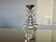 Ethnic “skeleton” candle holder in nickel-plated brass from the 80s