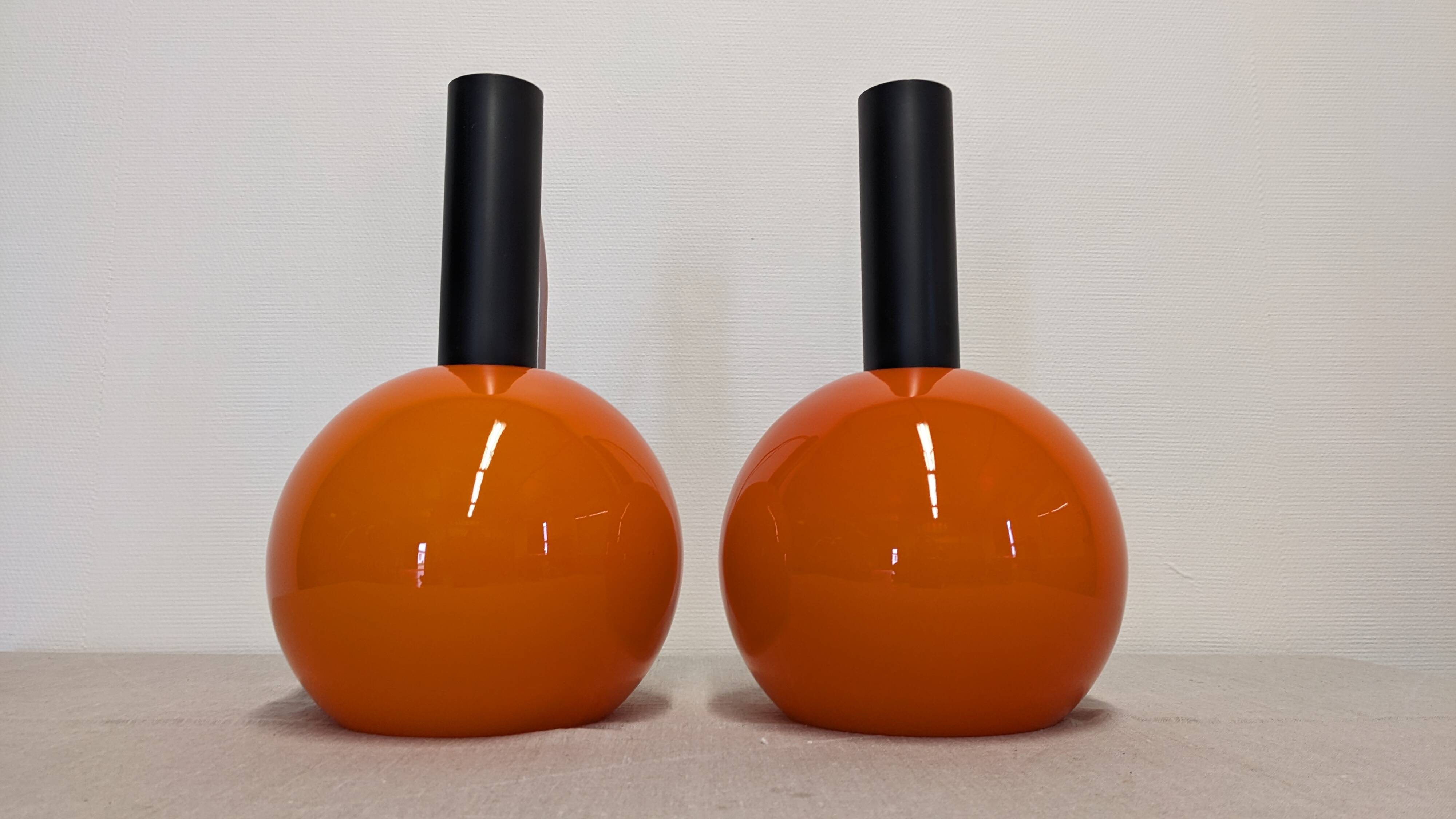 Pair of orange opaline ball pendants by Parscot, France circa 1970.