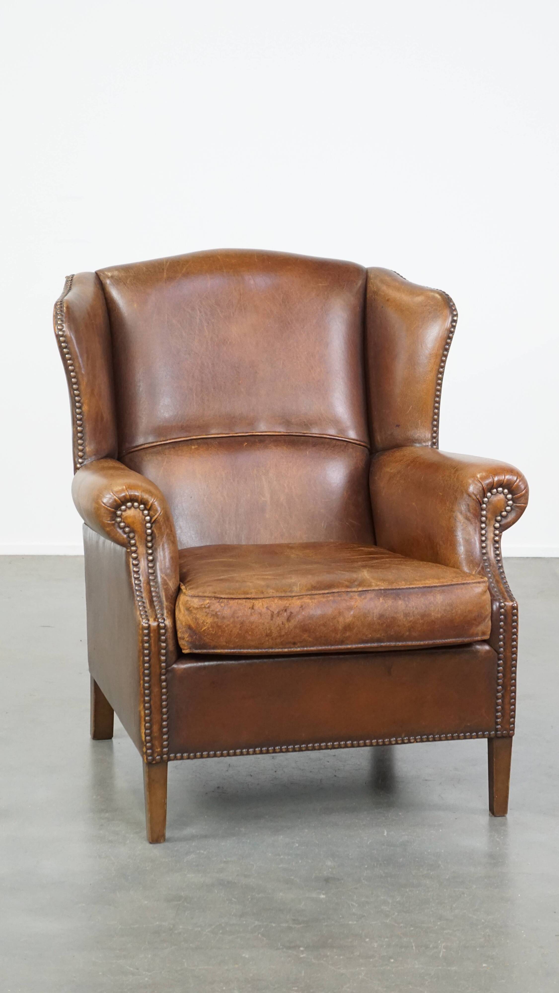 Cognac-colored sheepskin wing chair in English style
