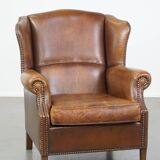 Cognac-colored sheepskin wing chair in English style