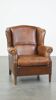 Cognac-colored sheepskin wing chair in English style