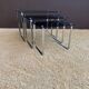 Set of 3 nesting tables in metal and smoked glass.