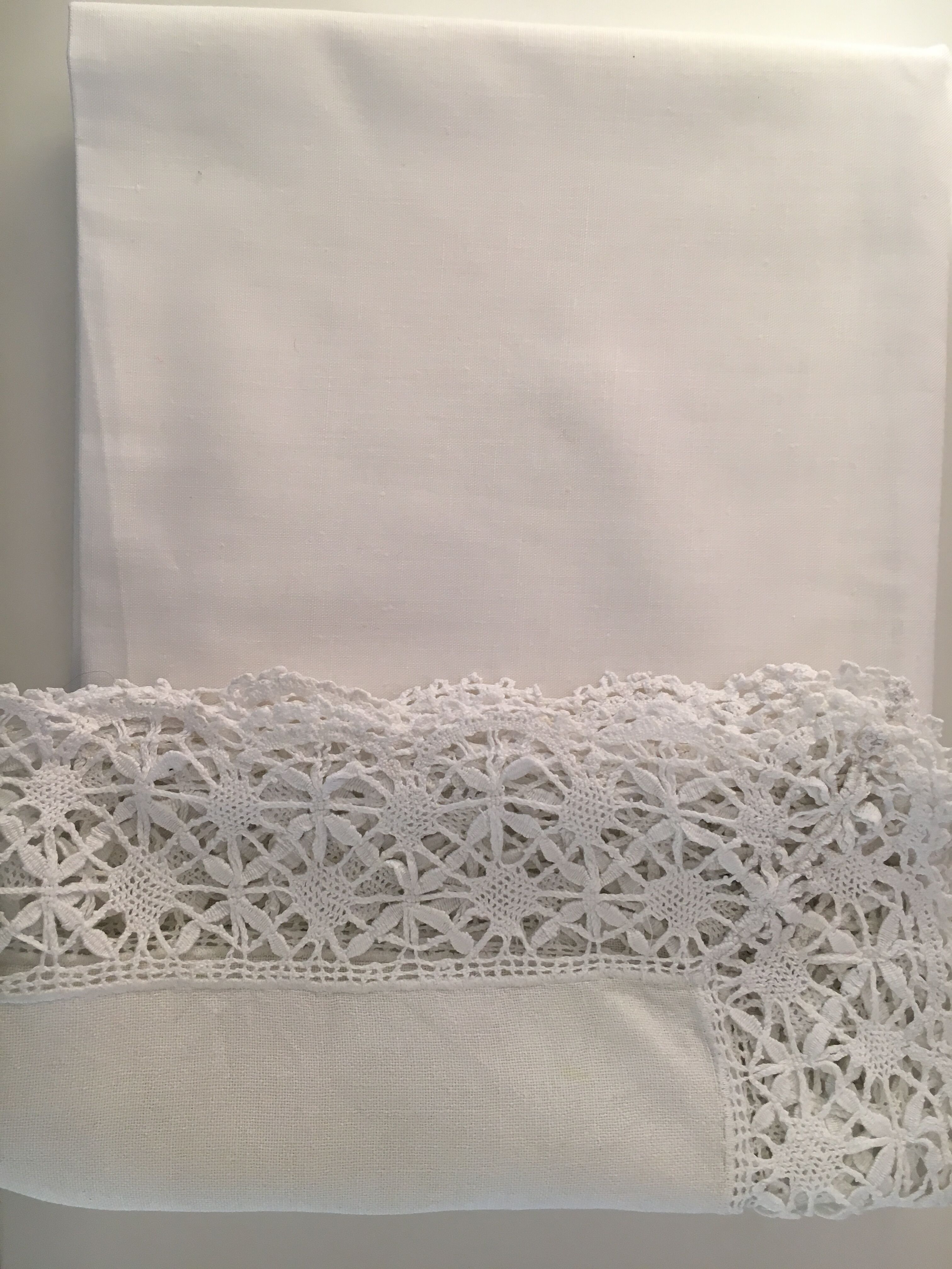 Old embroidered white linen and surnappe tablecloth