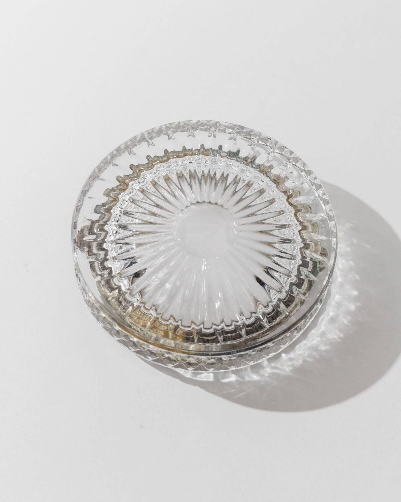 Vintage crystal glass ashtray from the 1920s, silver-edged with a textured pattern, Art Deco table decoration.