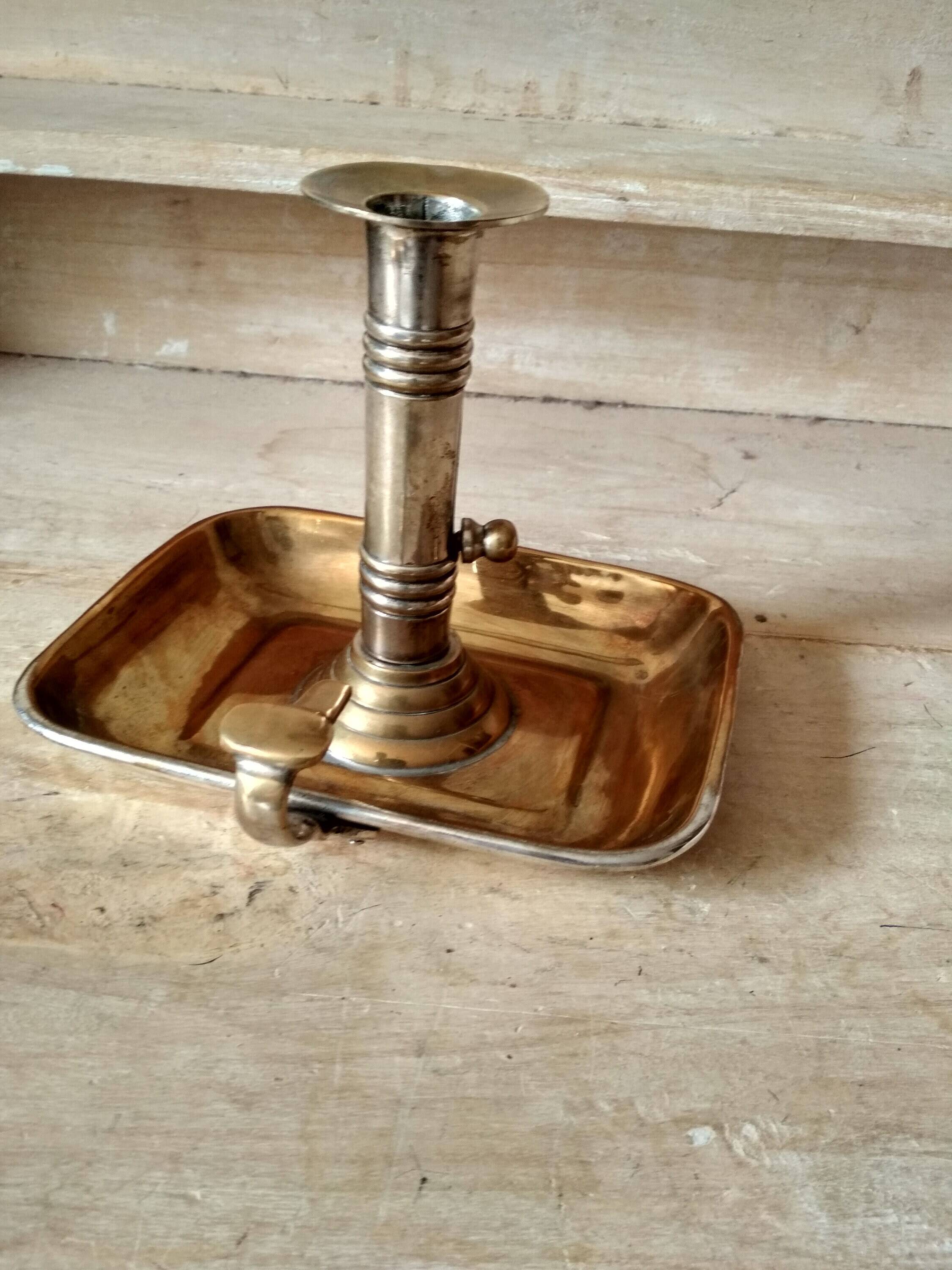 Antique metal and brass hand candle holder on rectangular base