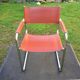 Design armchair with base in chrome tubular steel and seat in brown leather