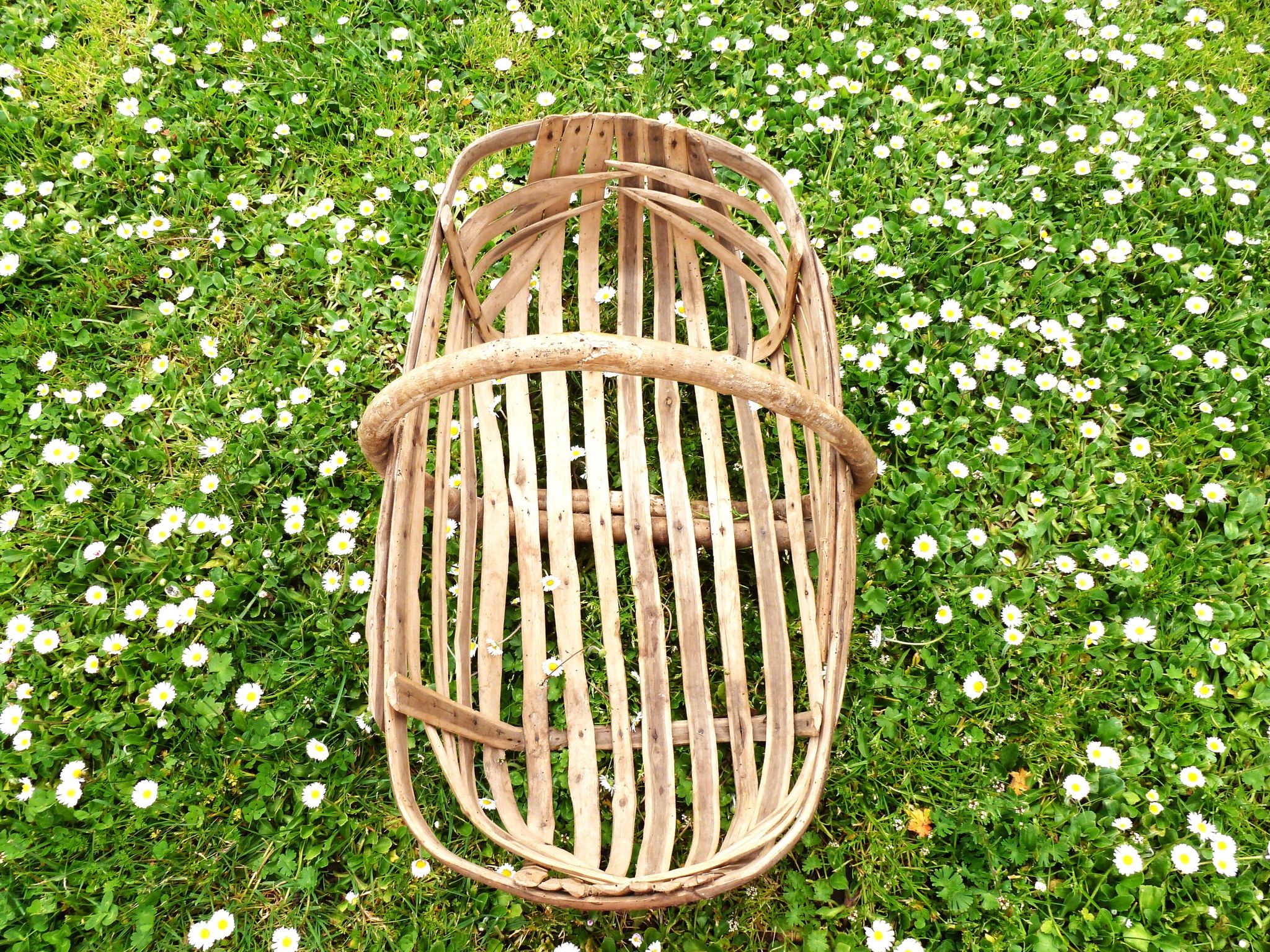 Old wooden harvest basket, slatted wooden basket, folk art.