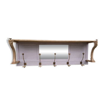 Coat rack or wall-mounted entrance wardrobe with scroll arms and antique hooks.