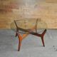 Mid-century coffee table in brown teak with a floating tempered glass top.