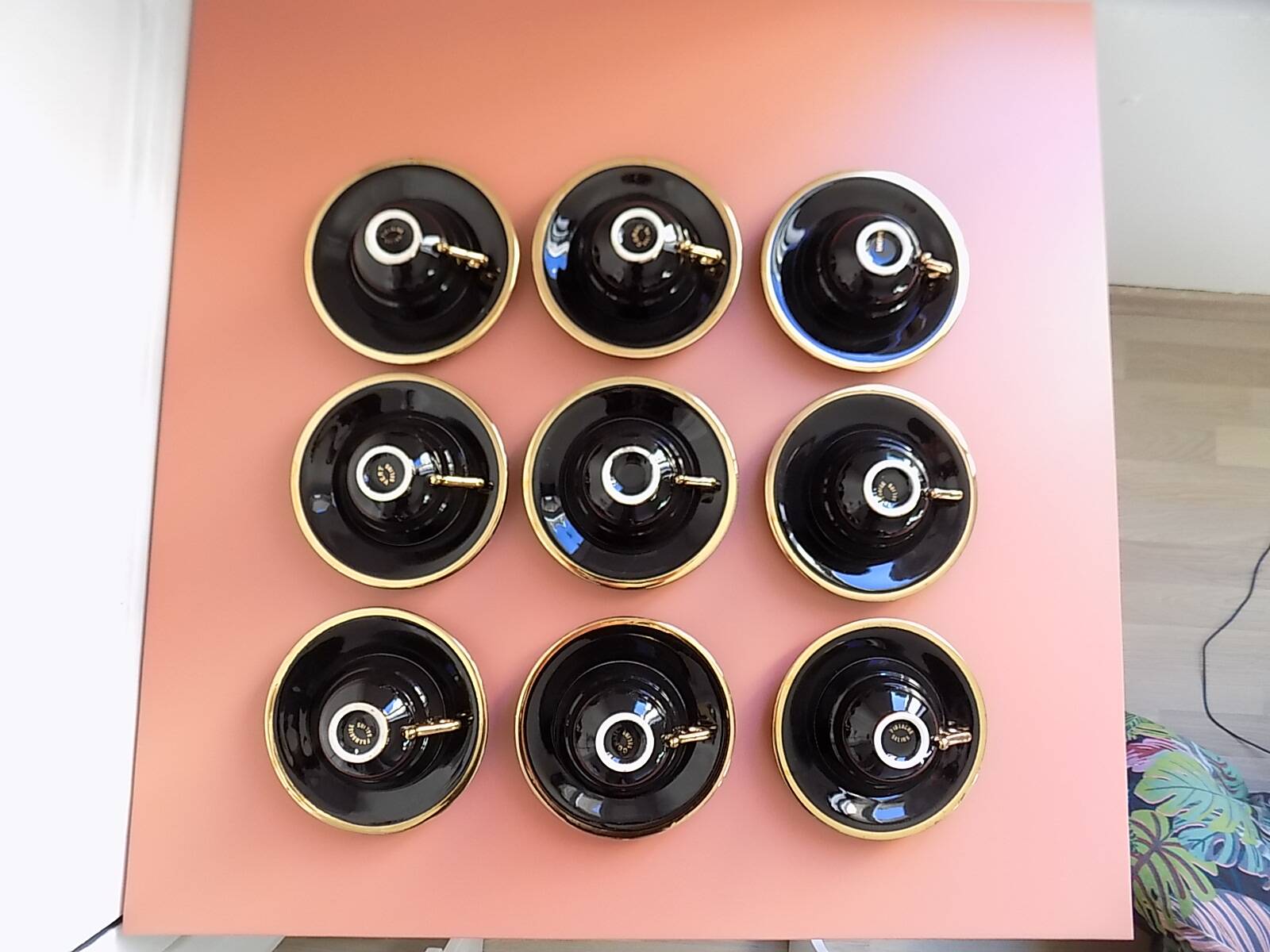 set of 9 black and gold Salins cups and saucers