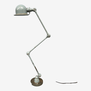 Blue-grey three-armed Jielde lamp on an iron base