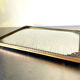 Metal frame in gold colored brass