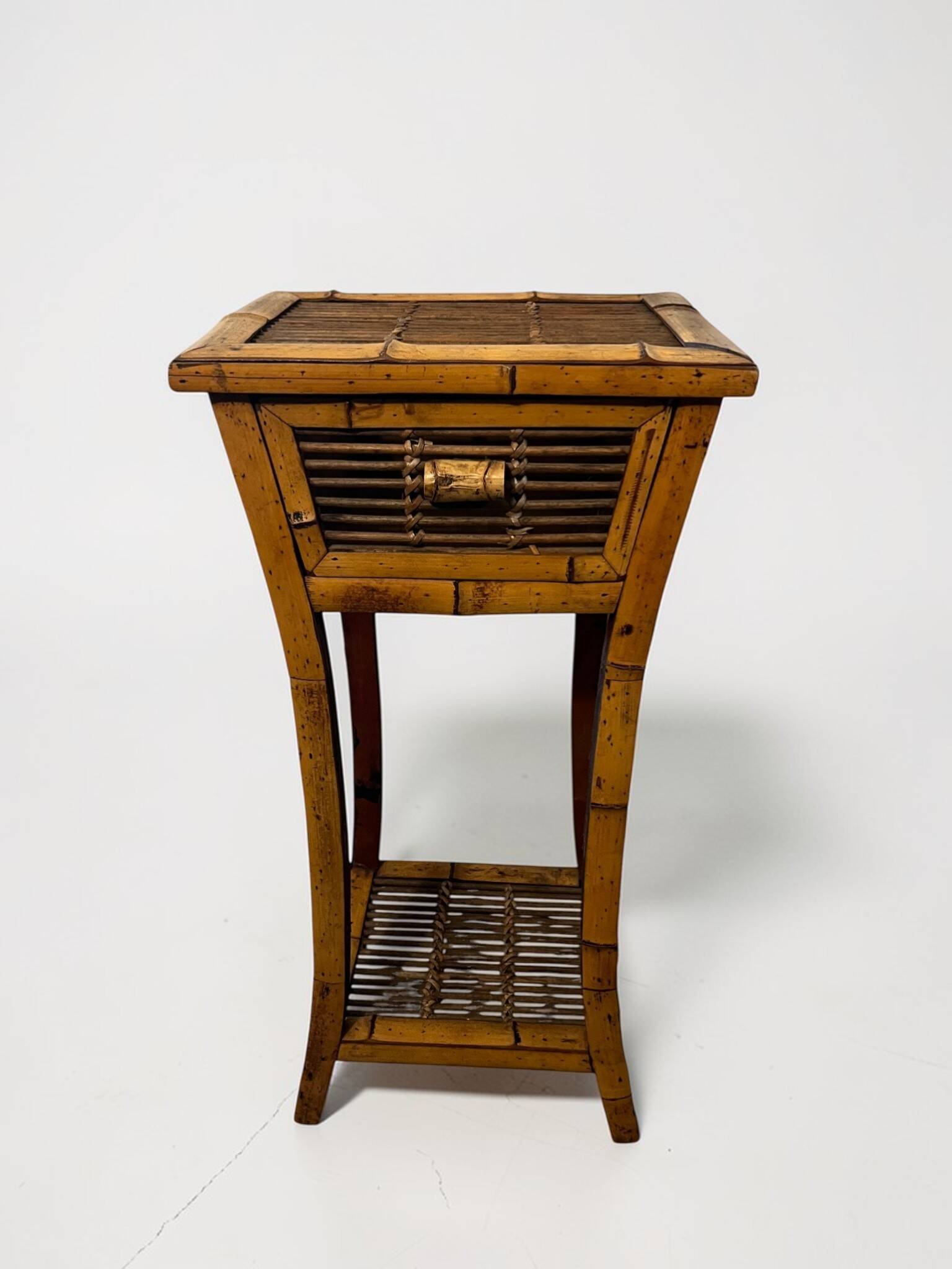 Vintage bamboo side table with drawer from the 20th century.