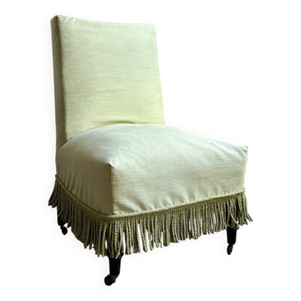 Fauteuil, chauffeuse en coton vert et bois noir sur roulettes