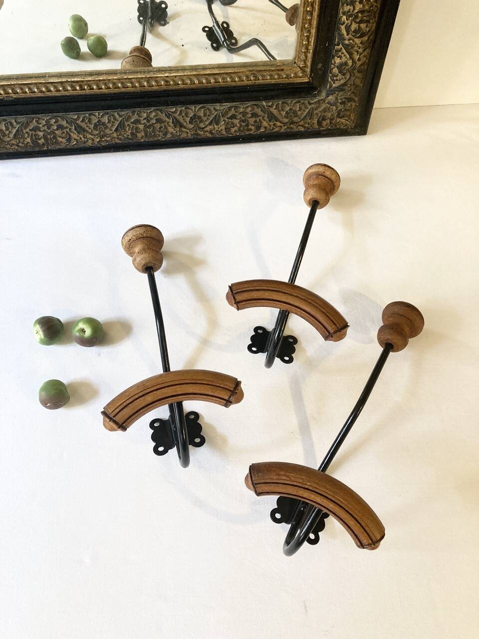 Trio of antique wooden and metal coat hooks