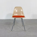 DSX chair with red cushion by Charles and Ray Eames edited by Herman Miller, 1960
