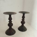 Two pairs of patinated brass candle holders