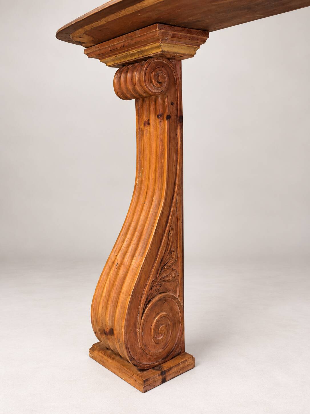 Old console in carved wood with scrolls