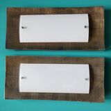 Pair of wall sconces in gold-plated alloy with bas-relief and opaline glass. Germany, 1980