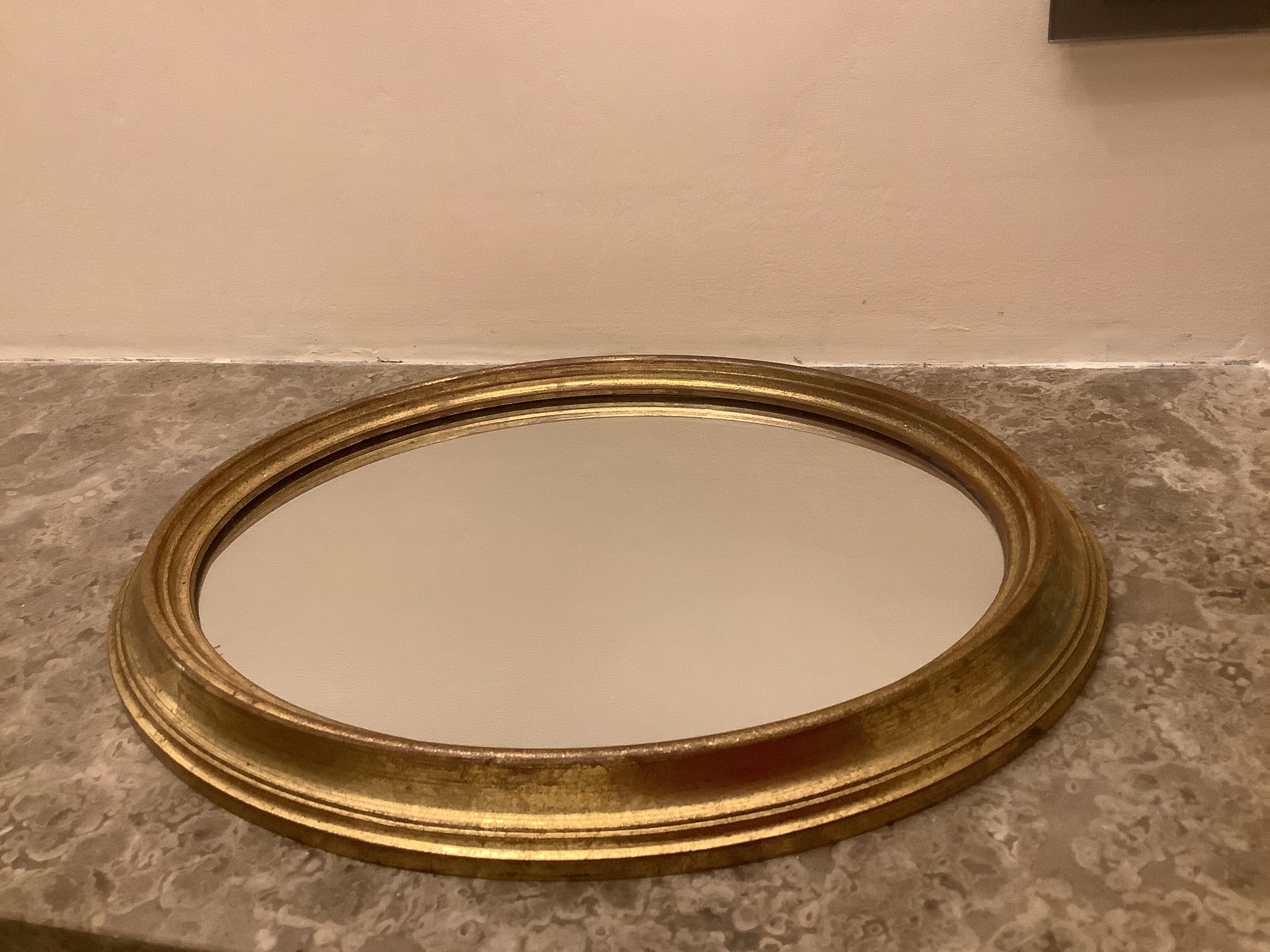 Golden oval mirror