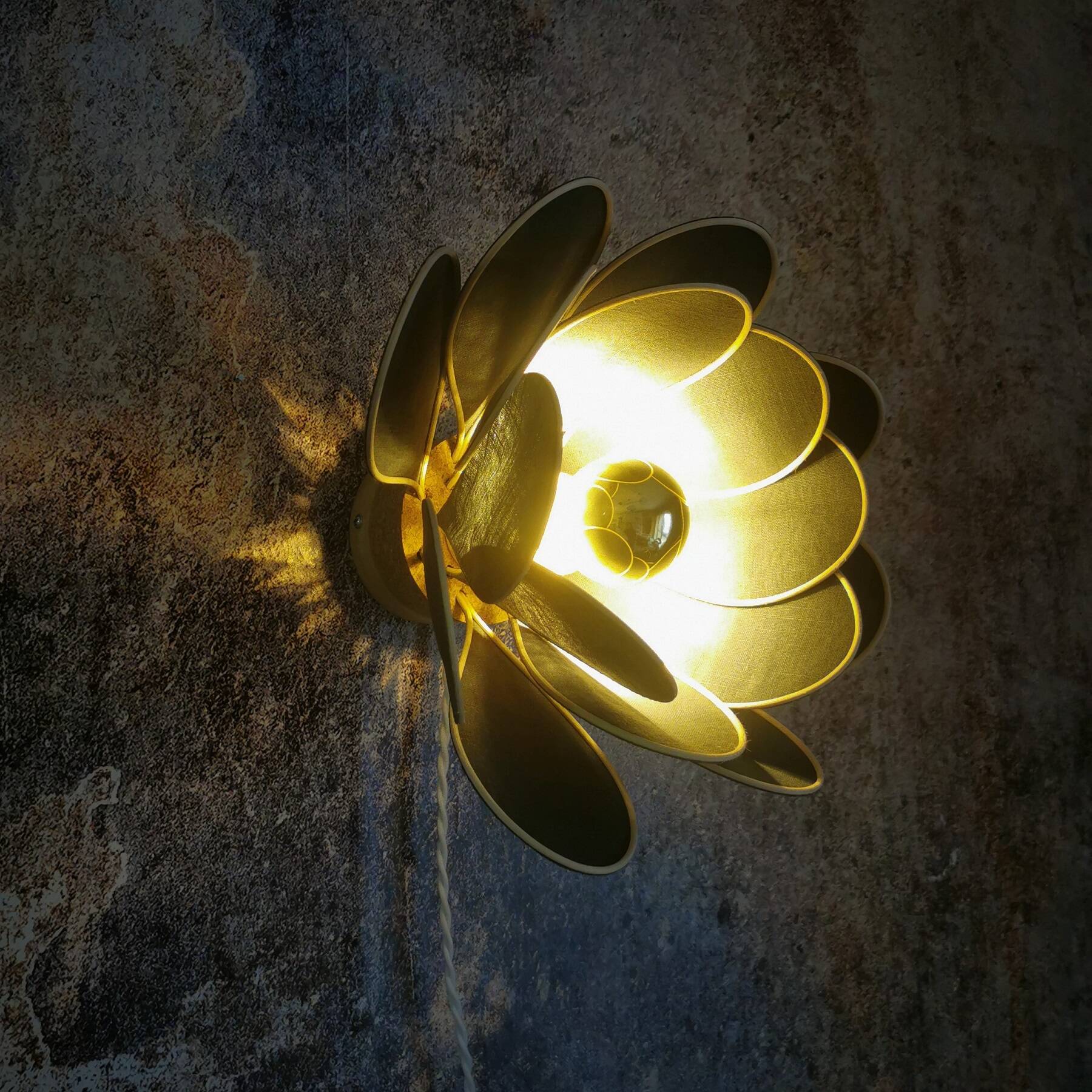 Wall lamp flower made of rattan and fir green linen.