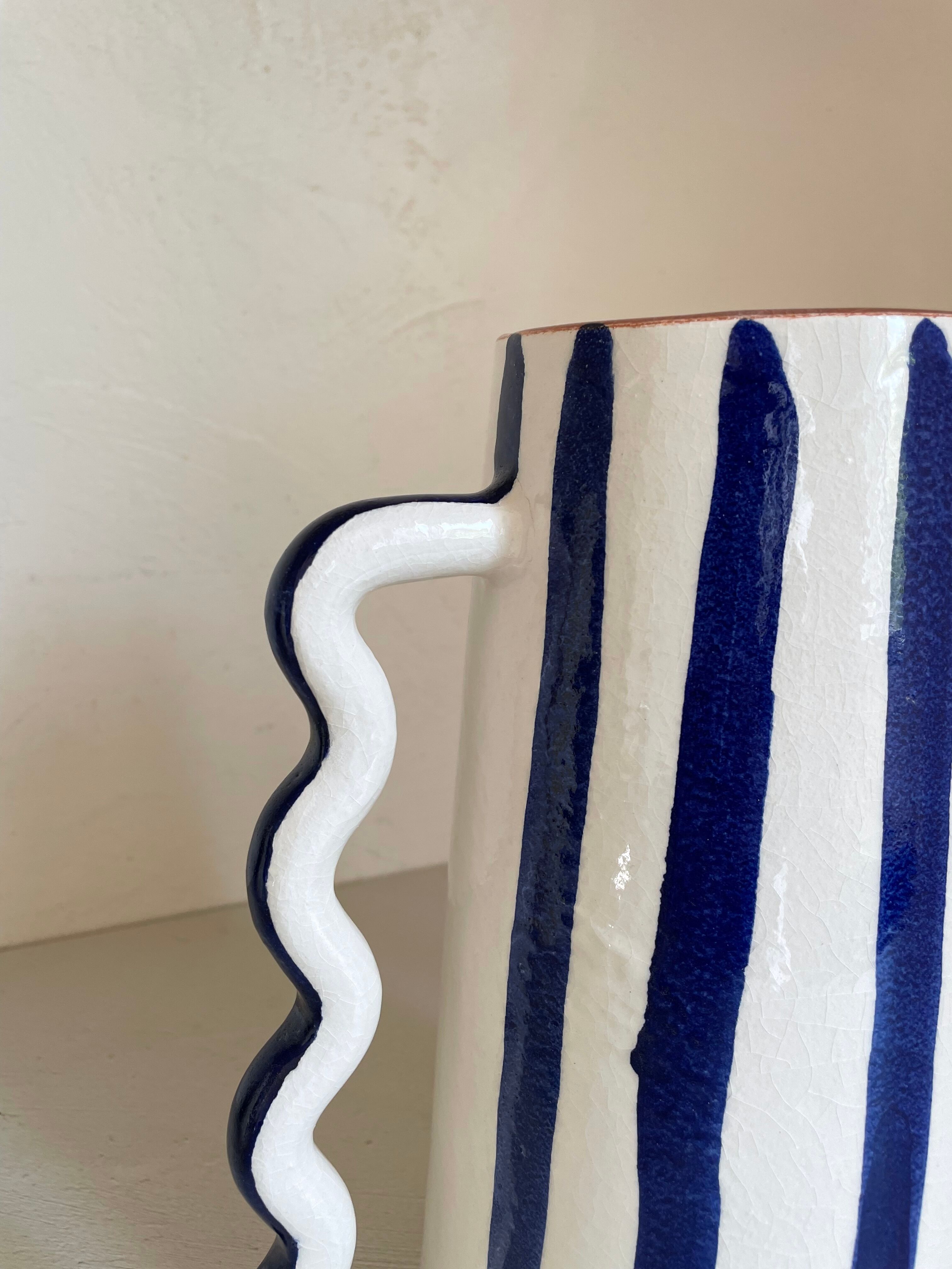 Klein blue and white striped ceramic vase with abstract handmade wavy handles