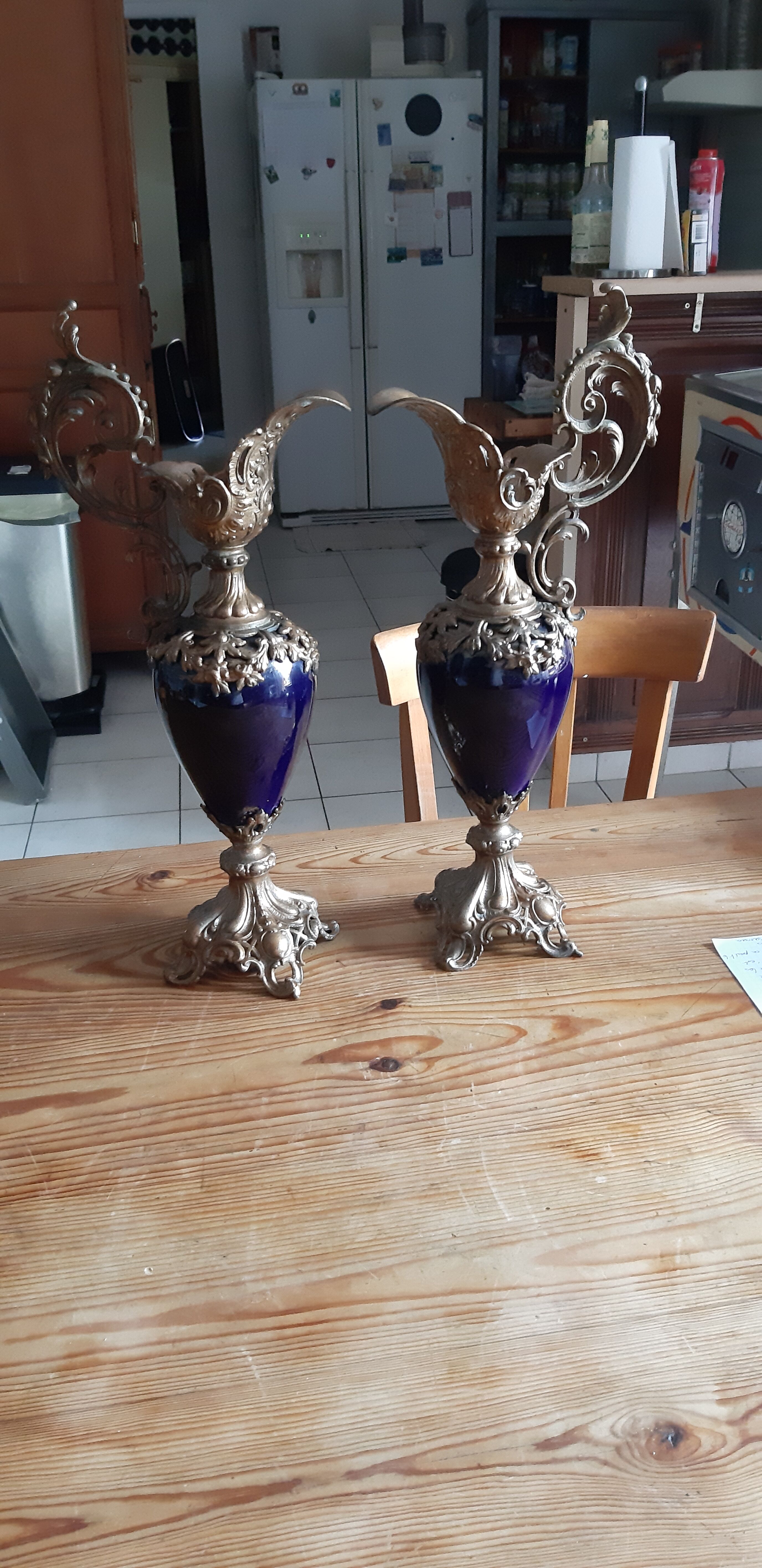 Pair of golden regulated ewers and blue glass