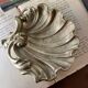 Bronze “shell” pocket emptier
