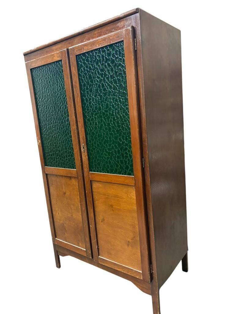 Vintage wooden display cabinet with green glass.