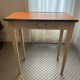 Orange wood and formica table
