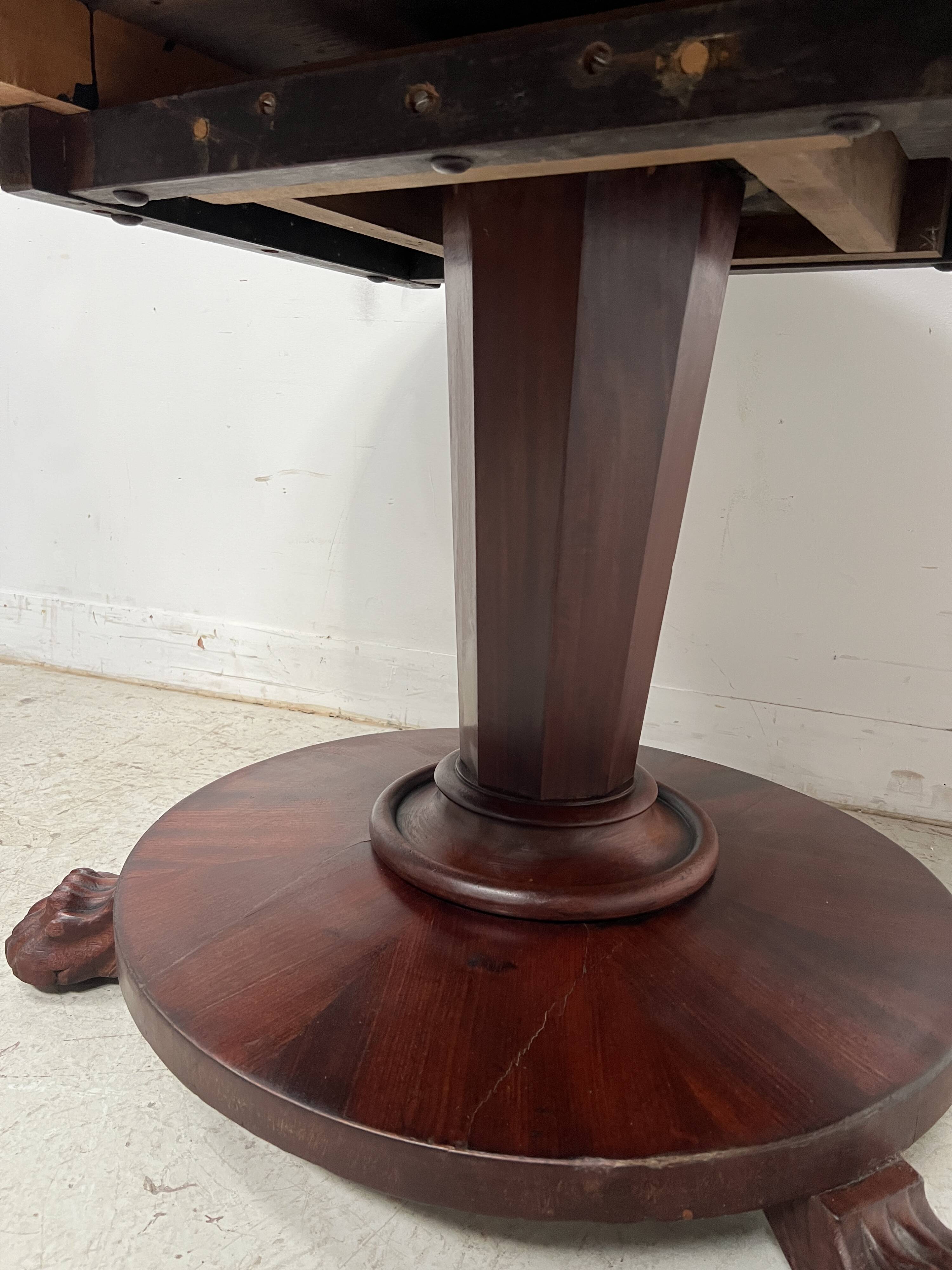 Empire style round table with claw feet, 19th century.