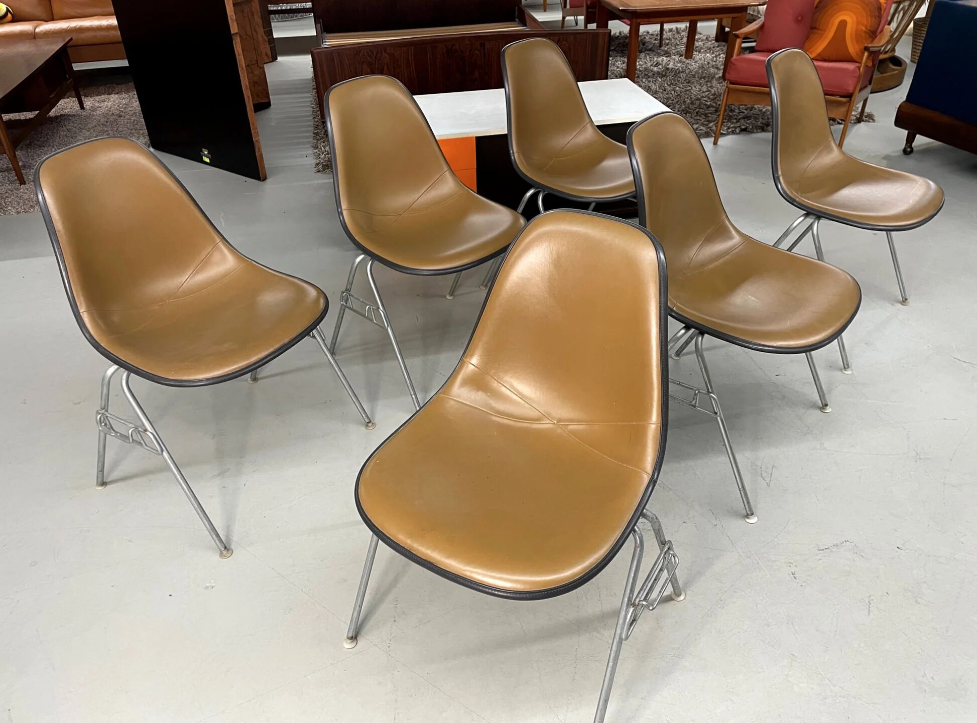 6 Herman Miller Eames stacking shell chairs with brown naugahyde pads