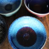 A set of 4 pottery bowls in coloured glaze.