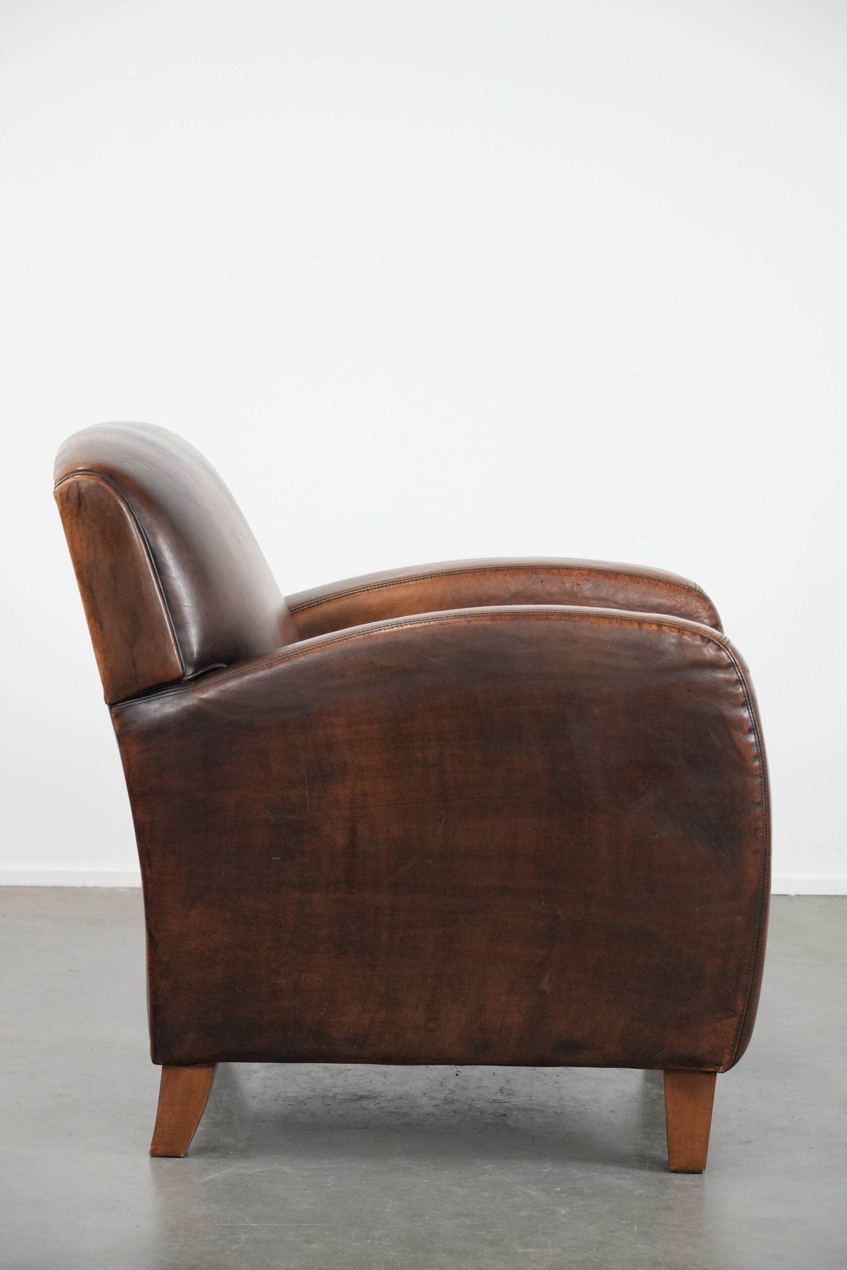 Beautifully shaped vintage sheepskin armchair with character