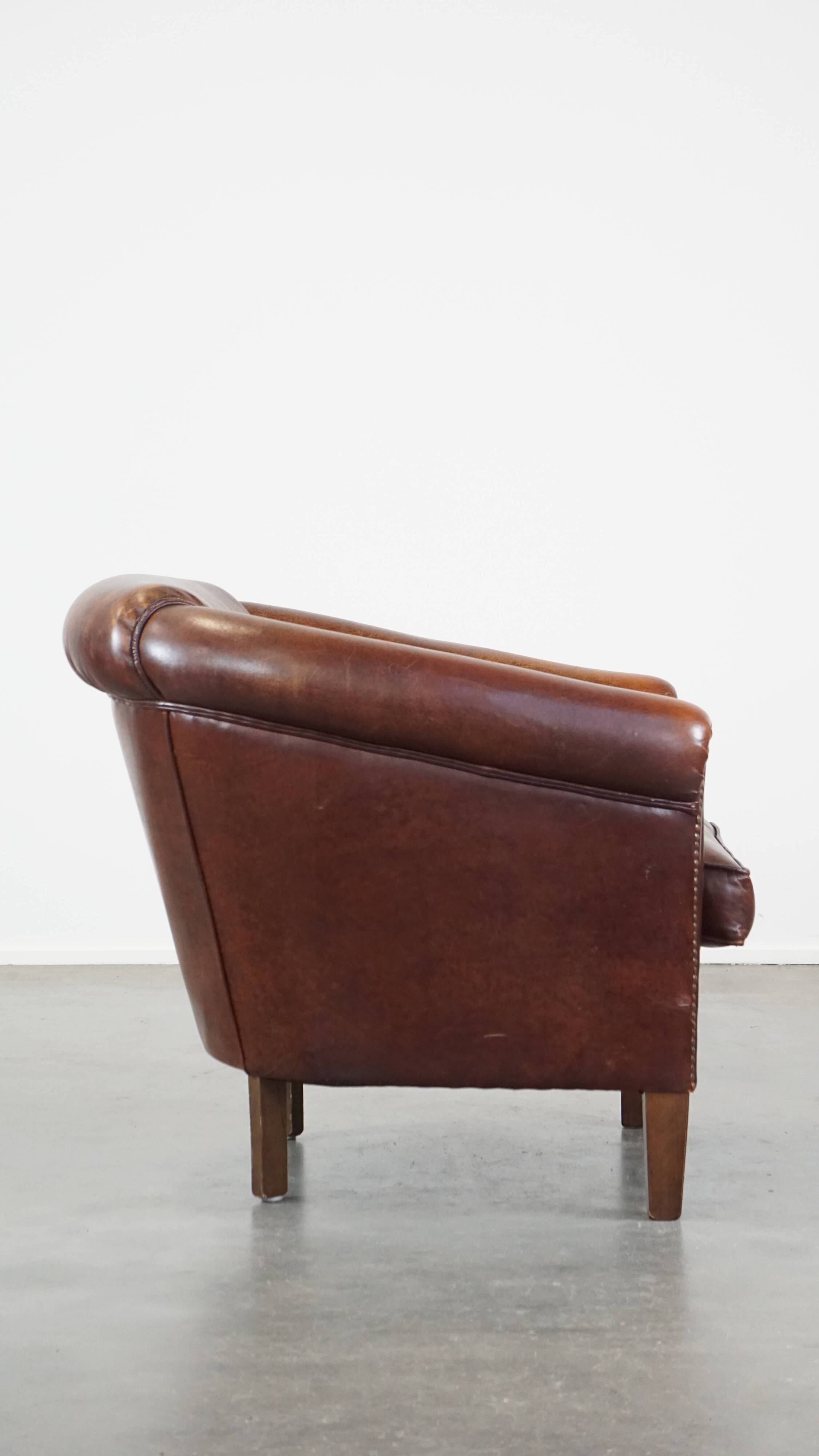 Sheepskin club armchair, correct finishing with decorative nails