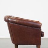 Sheepskin club armchair, correct finishing with decorative nails
