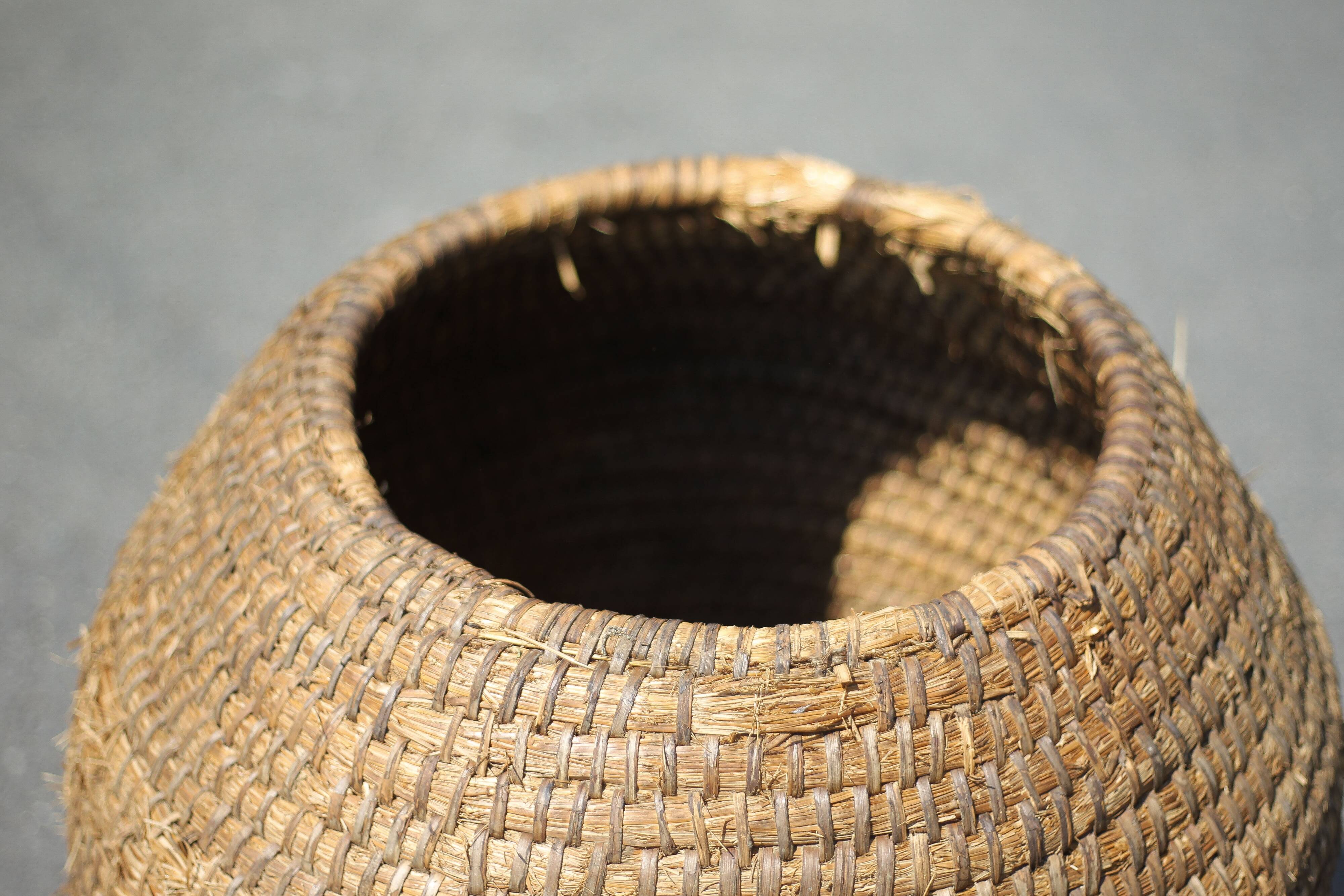 Very large old basket, burgundy straw and bramble, woven basket