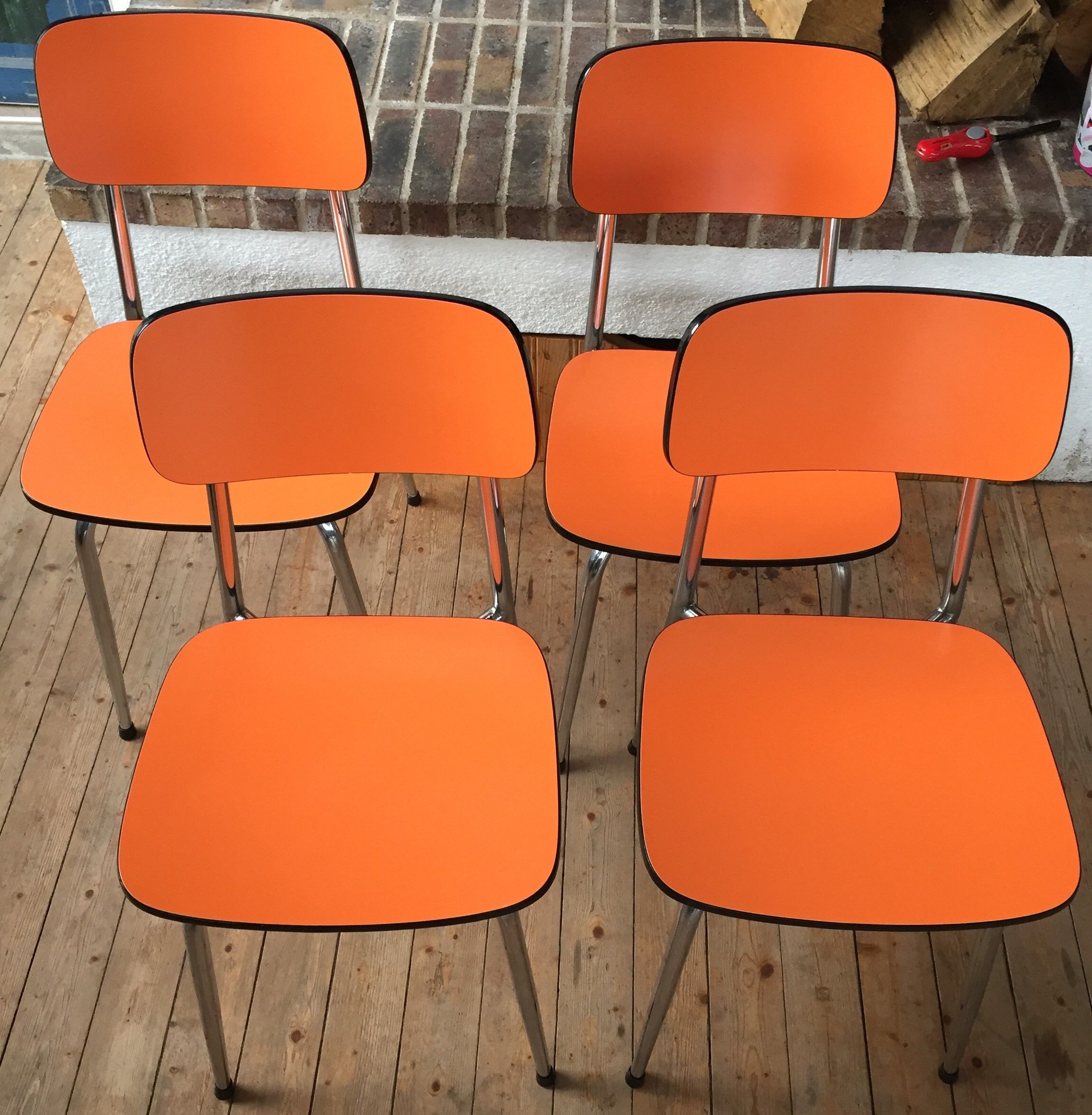 Lot of 4 vintage chairs in orange formica
