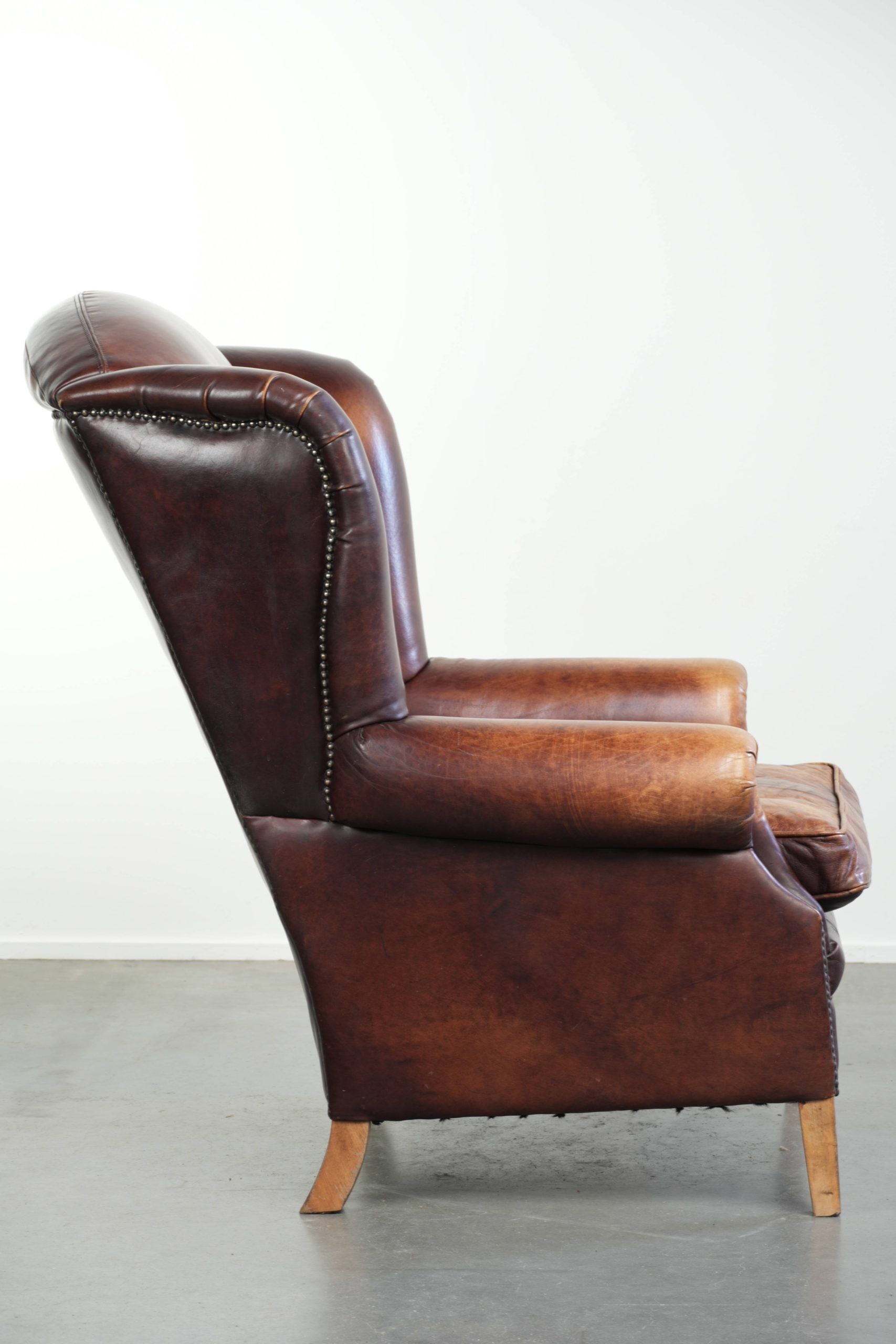Comfortable cowhide wingback armchair in English style