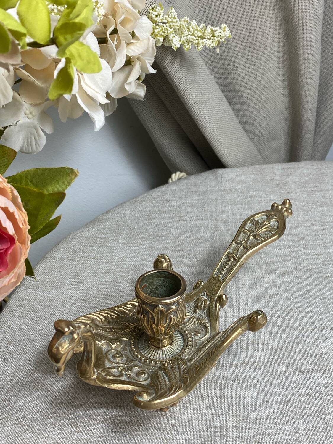 Bronze hand candlestick in the shape of a peacock