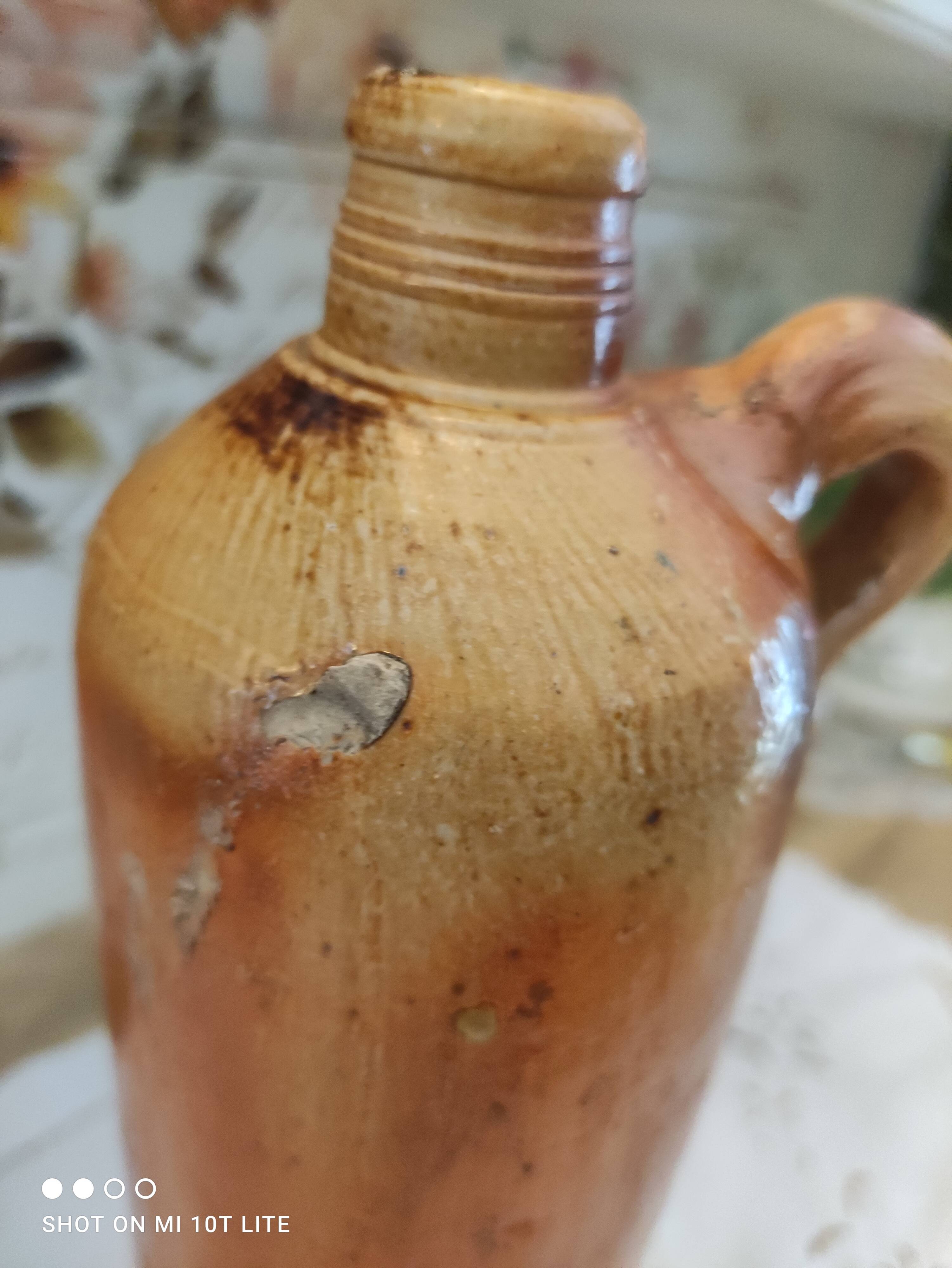 Old bottle in terracotta varnished finish