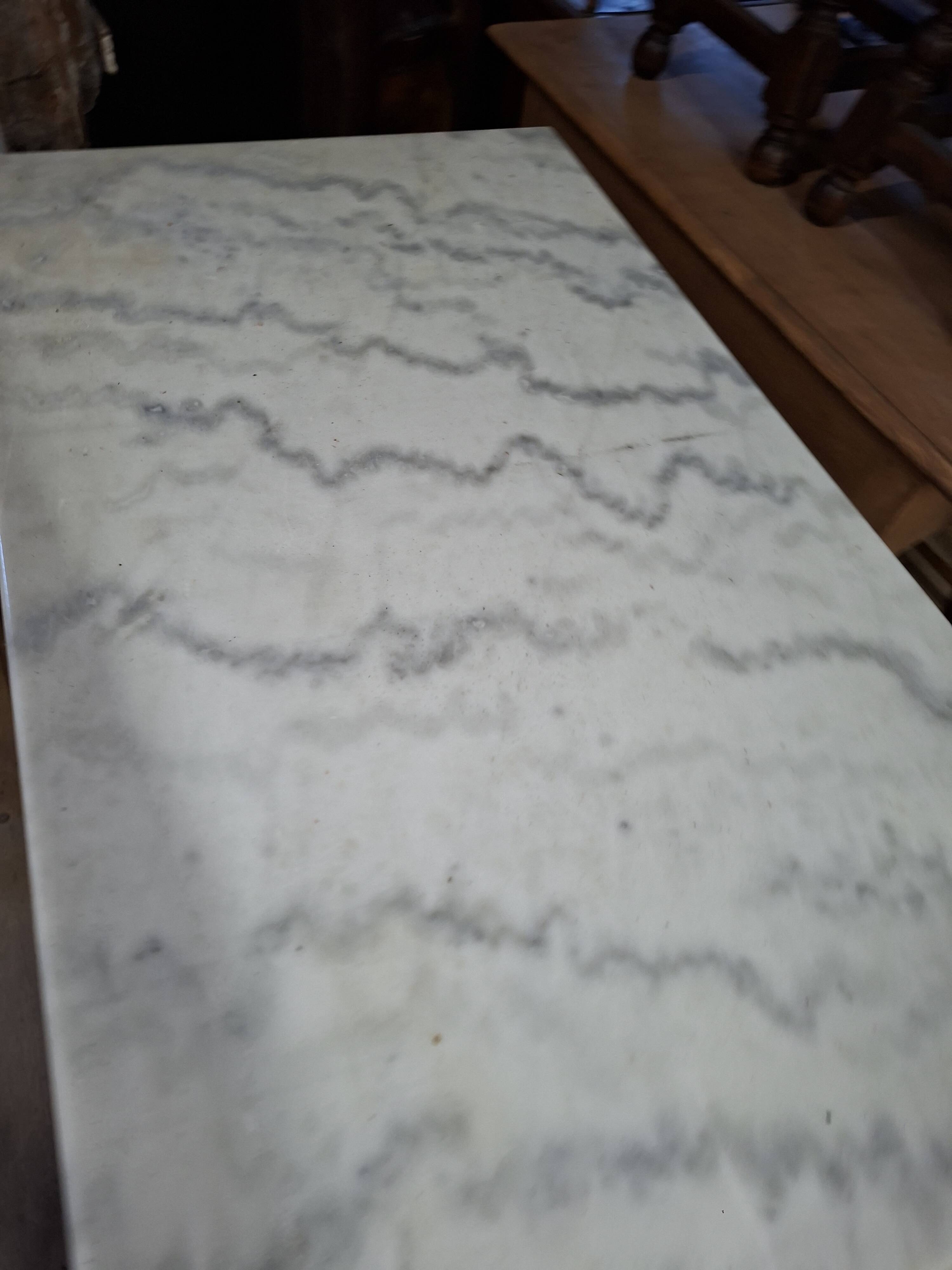 Pair of bistro tables in marble and cast iron.