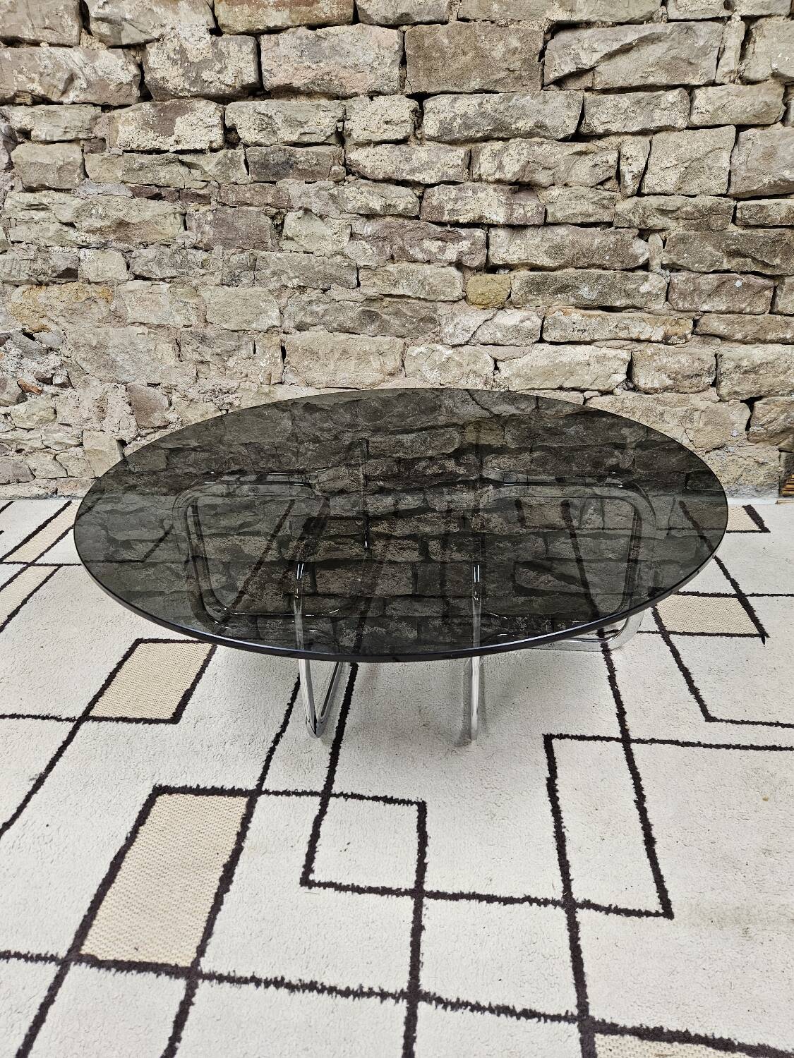 Round chrome coffee table with smoked glass