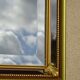 Hallway mirror, gilded frame, curtains and fleur-de-lis