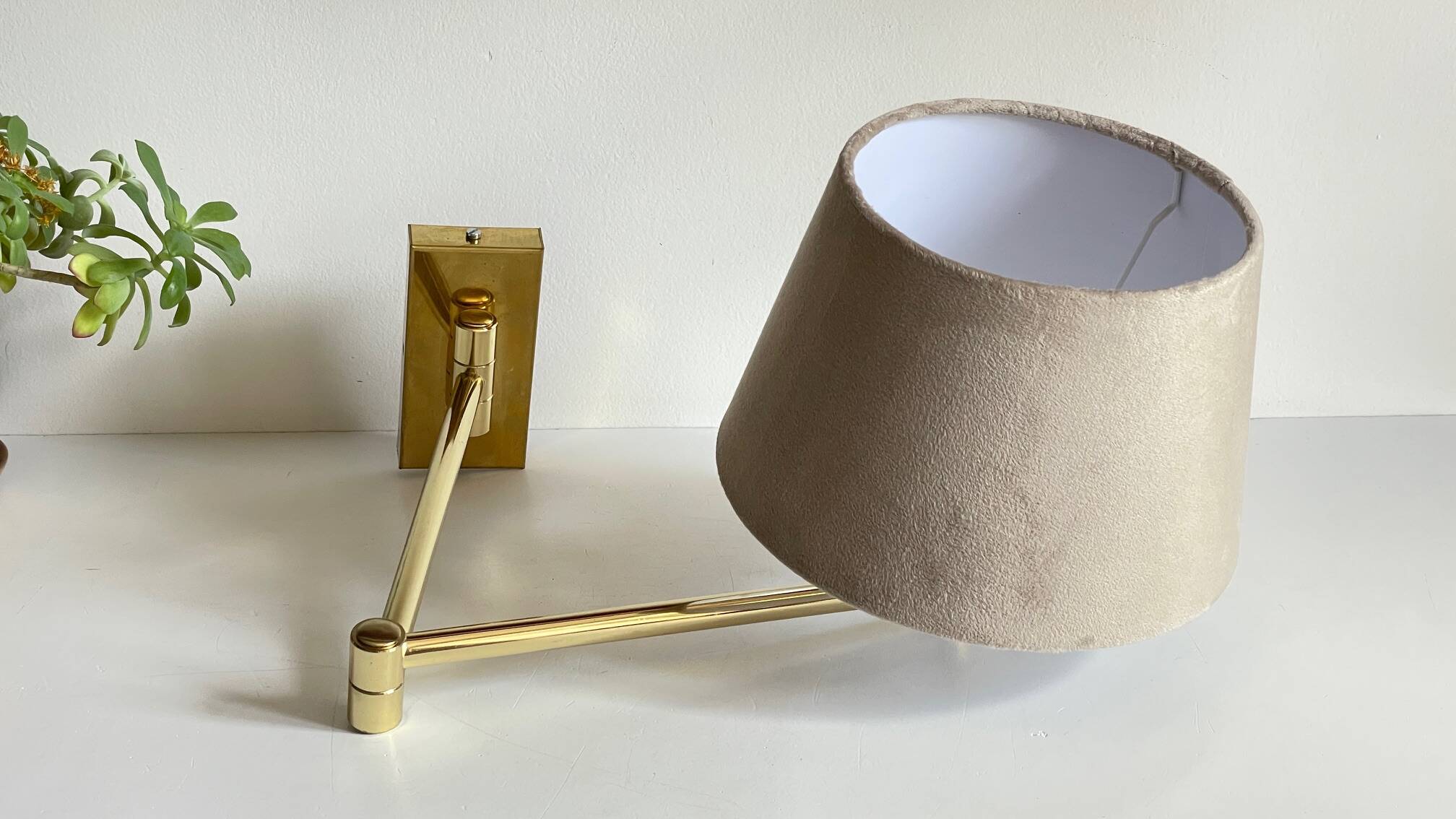 articulated brass and velvet wall light