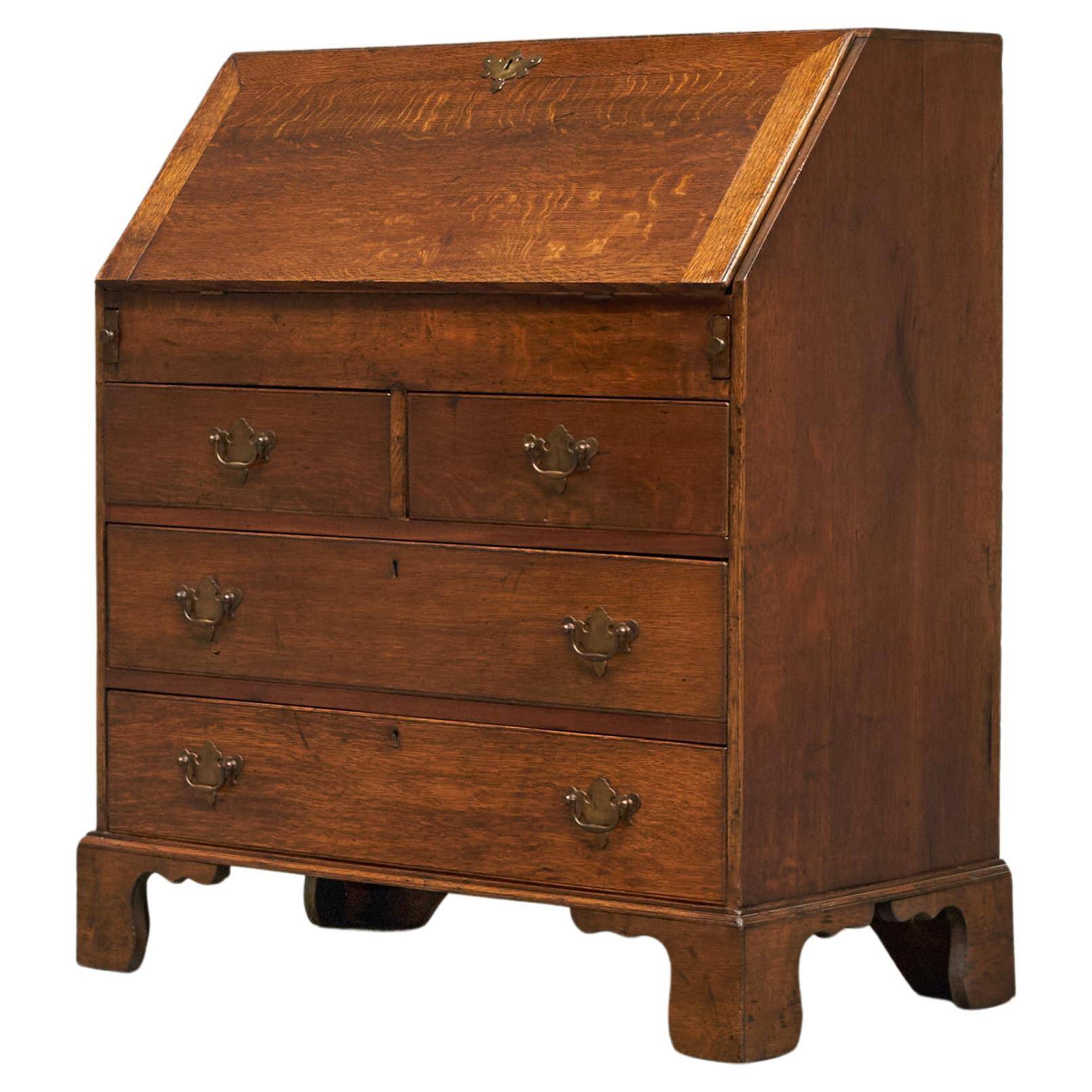 Antique English oak secretary with drop-down front.