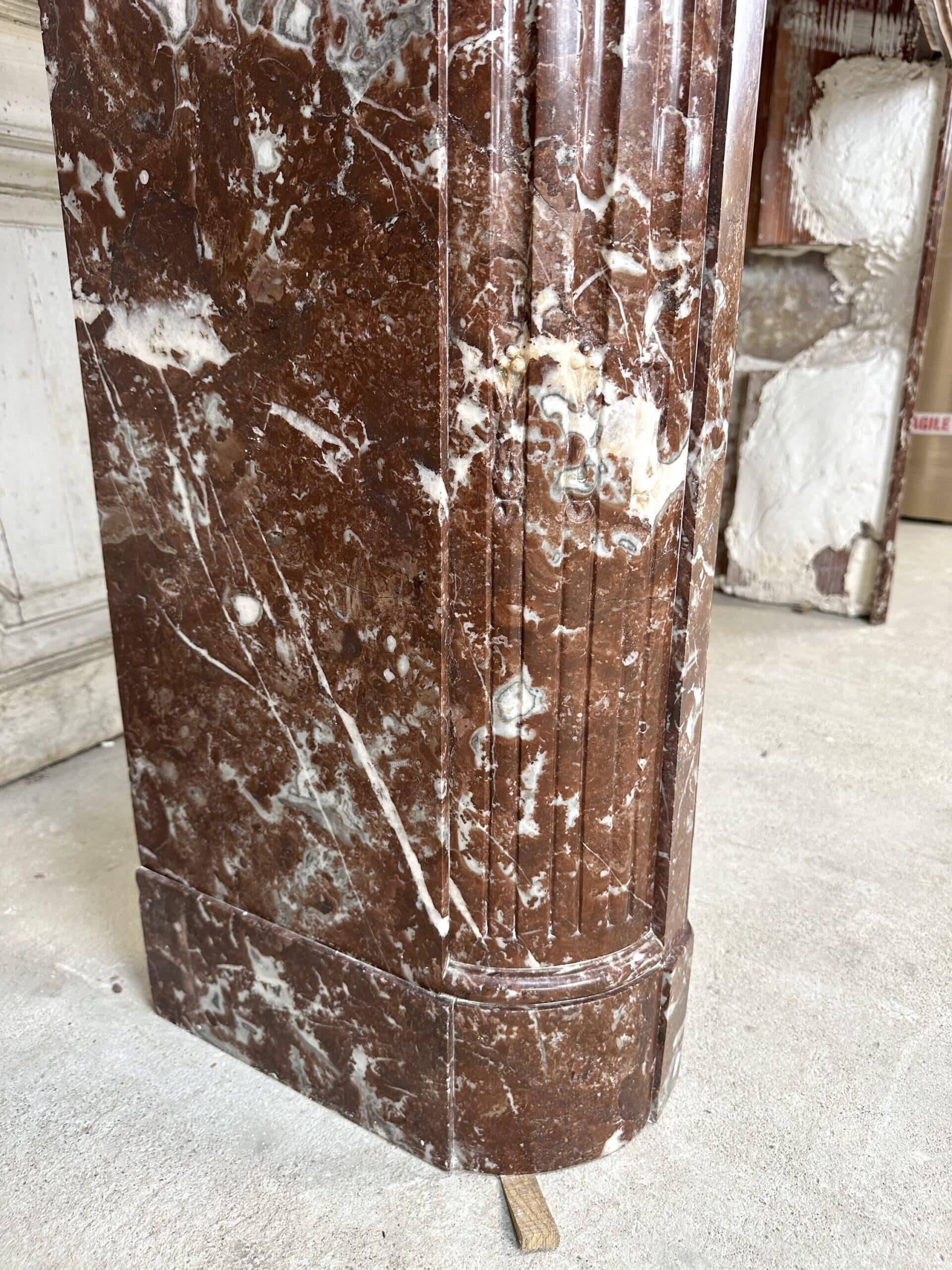 Red marble fireplace in the Louis XVI style, late 19th century