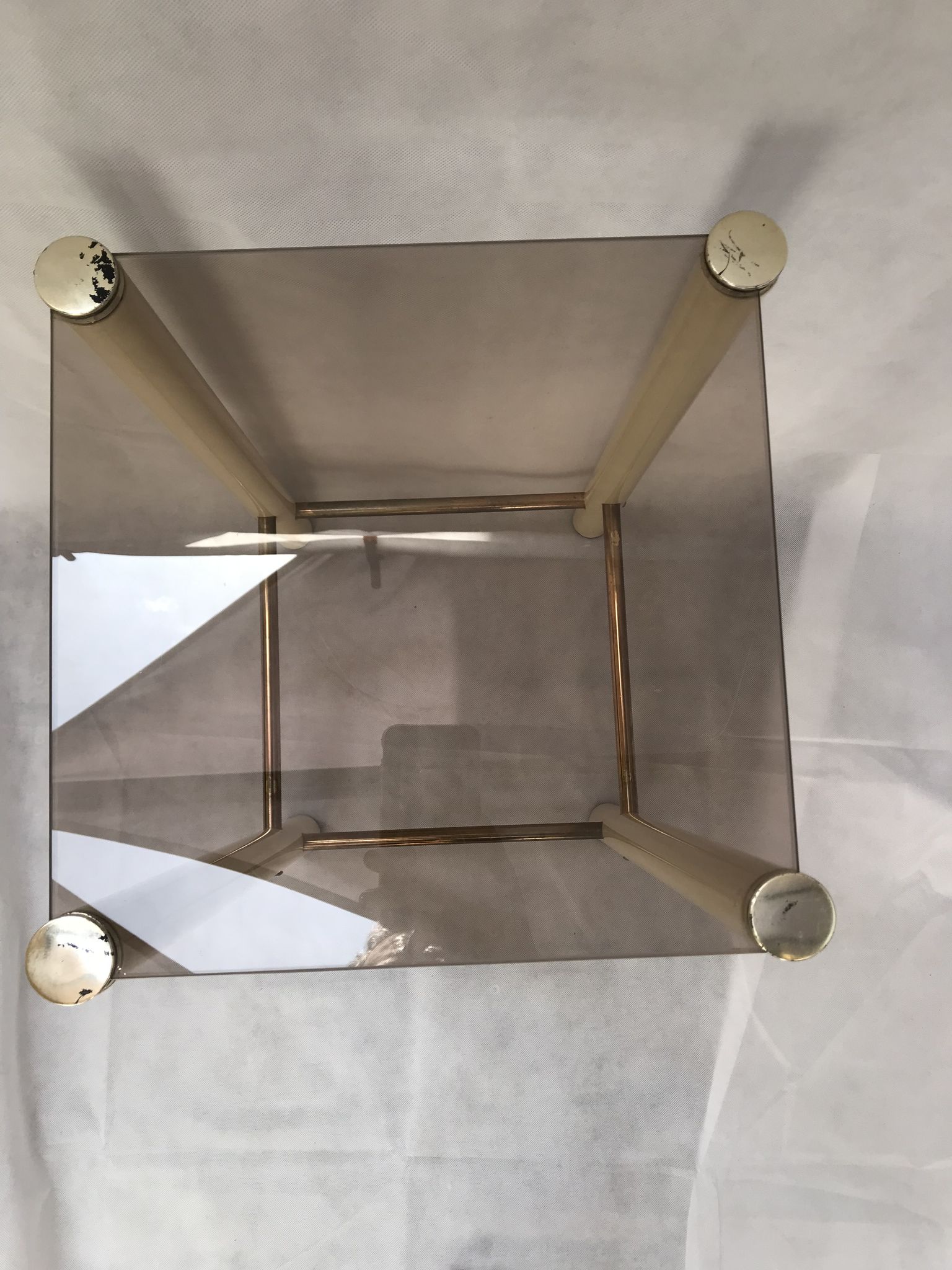 Square side table in metal and smoked glass.